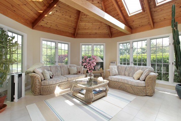 Sunroom with wood beams in luxury suburban home